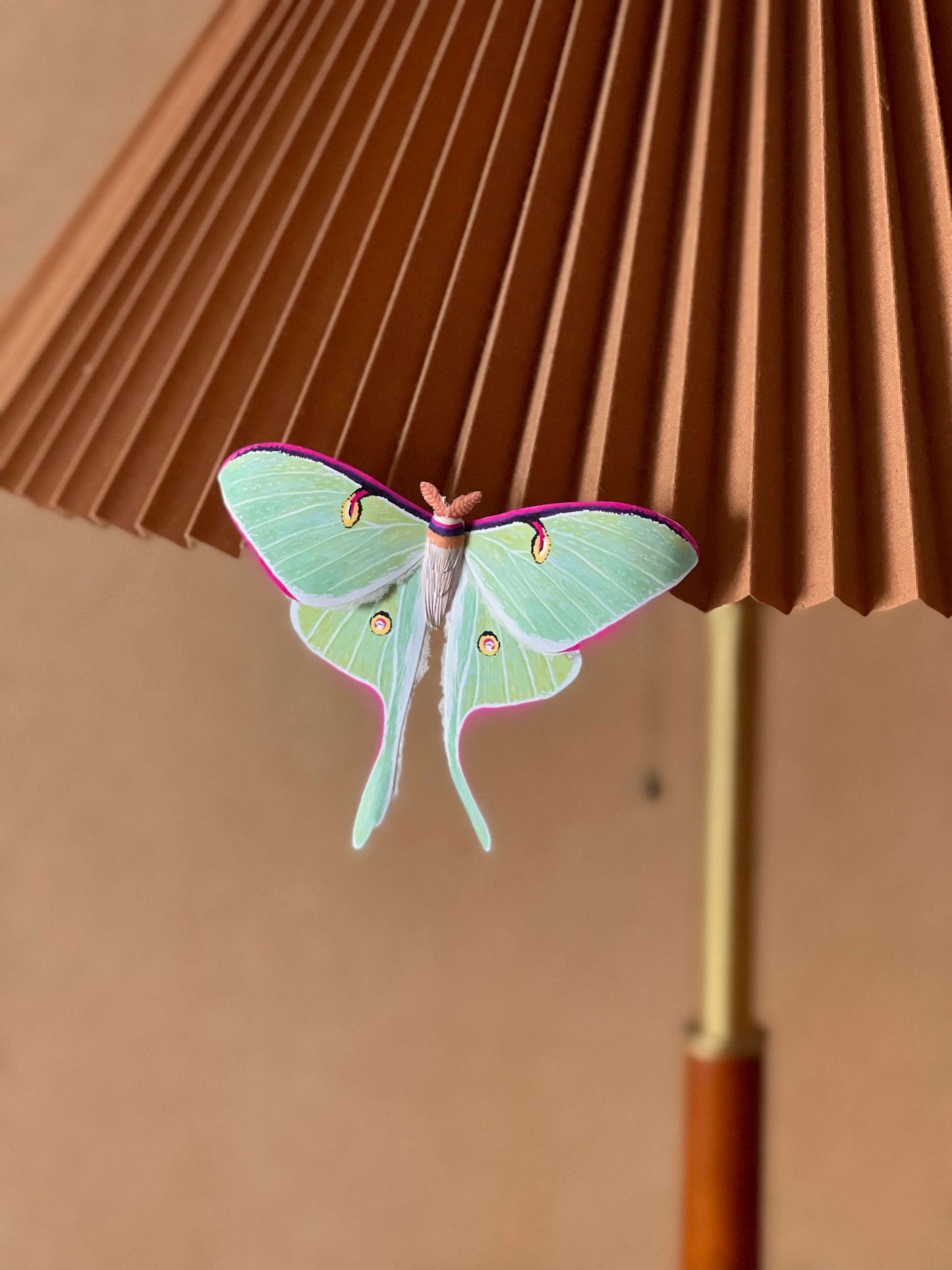 Paper Moth, realistic paper luna moth, moon moth perched on a lamp