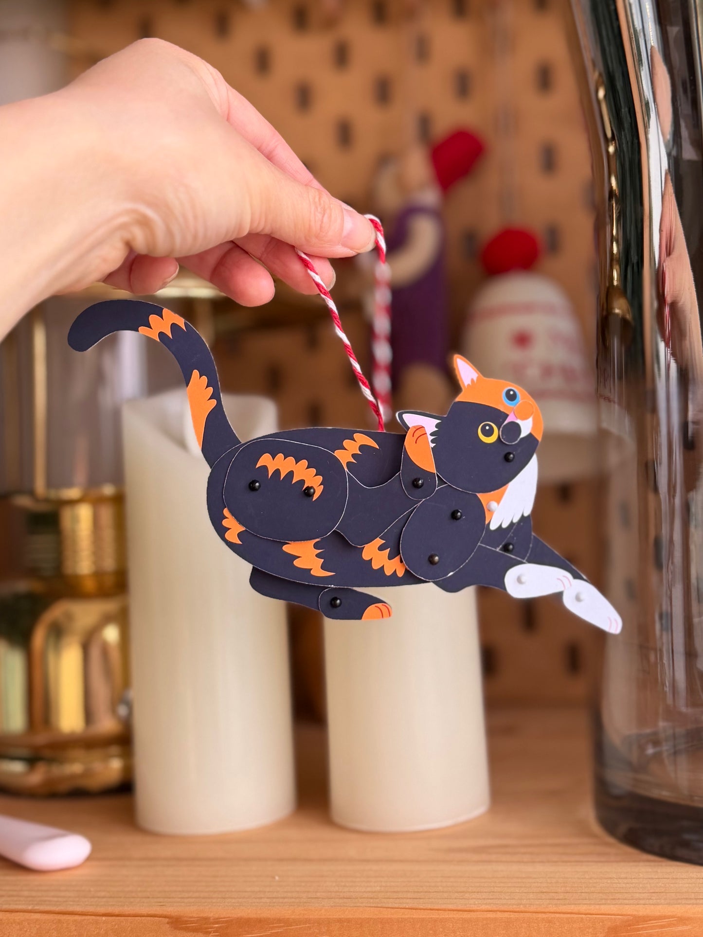 Hand holding a Chimera Two-Faced Cat Paper Doll