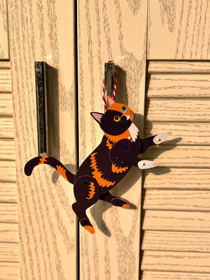 Decorative cat ornament on a wooden surface, Chimera Two-Faced Cat Paper Doll