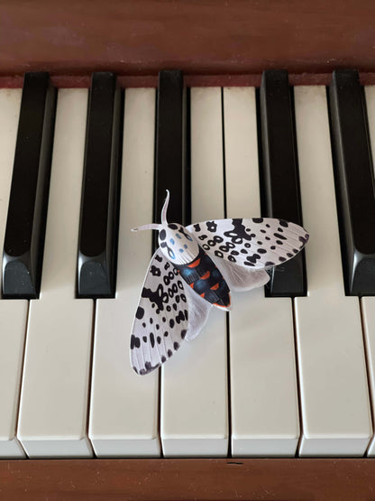 DIY Paper Giant Leopard Moth on a piano keyboard