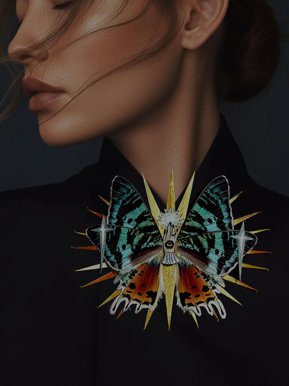 Madagascar Ray, Fantasy Paper Moth ased on Madagascan Sunset Moth, a woman wearing a butterfly-shaped brooch with a dark background